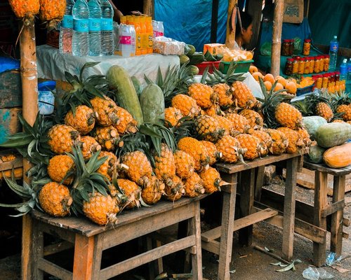 Fresh local fruits including mango and papaya on a wooden table